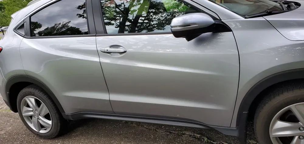 The same silver SUV door after dent repair, smooth and color matched with no crease left